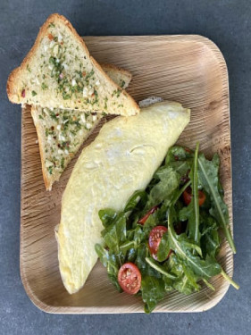 Parisian Omelette With Cheese Herbs Accompanied With Salad And Garlic Toast