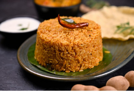 Tamarind Rice Meal With Sambar Raita And Papad