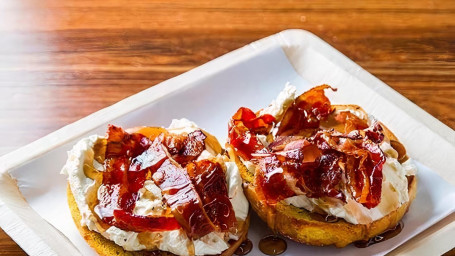Grilled French Toast Bagel Served With Cream Cheese, Bacon, And Maple Syrup.