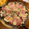 Pineapple And Ham Pizza In Squid Ink Sauce