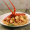 Twice Cooked Whole Lobster with Ginger and Shallots served on a Bed of Noodles