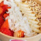 2 Bowl Topped With Banana, Strawberries, Coconut Flakes Almonds