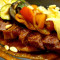 Tagliata di capocollo Cinta Senese con verdure al forno e pinoli tostati su crema di peperoni