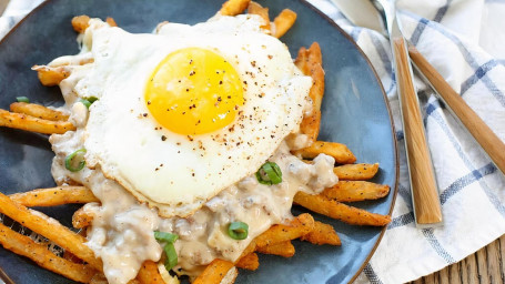 3 Eggs On A Plate With Cheese Fries